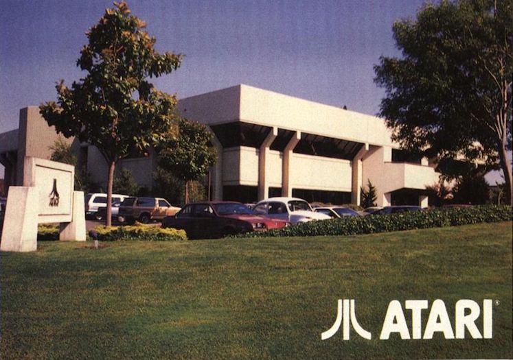 Atari’s headquarters building with parked cars and an Atari sign outside