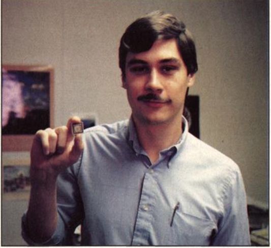 Duck Renn holding a small Blitter chip between his fingers
