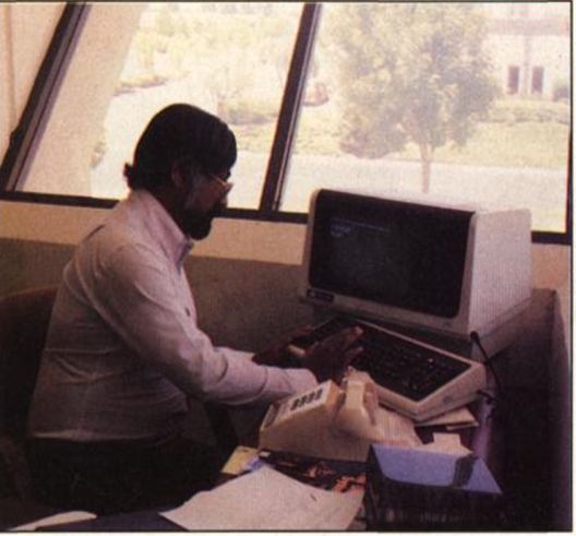 Shiraz Shivji typing at the terminal on his office desk
