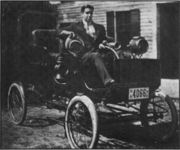 Clinton sitting in his Stanley around 1918