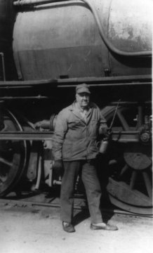 Clinton standing by his locomotive